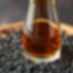A close-up view of black seed oil in a glass bottle surrounded by black seeds